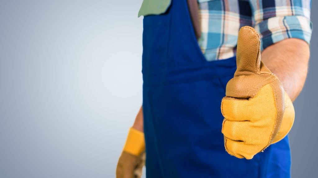 Handwerker mit Handschuhen und Daumen noch kurz vor dem Epoxidharz-entfernen